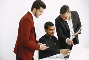 Executive search firms collaborating with leadership team reviewing candidate profiles and hiring strategy in office setting